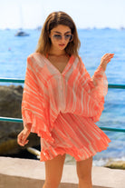 orange bloused silk kaftan dress to wear on warm holidays by Lindsey Brown luxury resort wear 